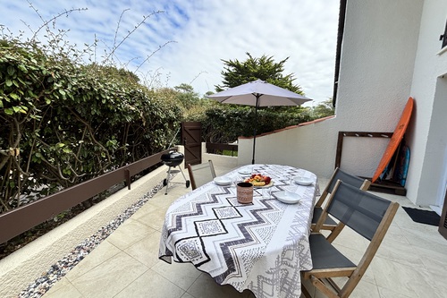 Sunny terrace with a surfboard rack